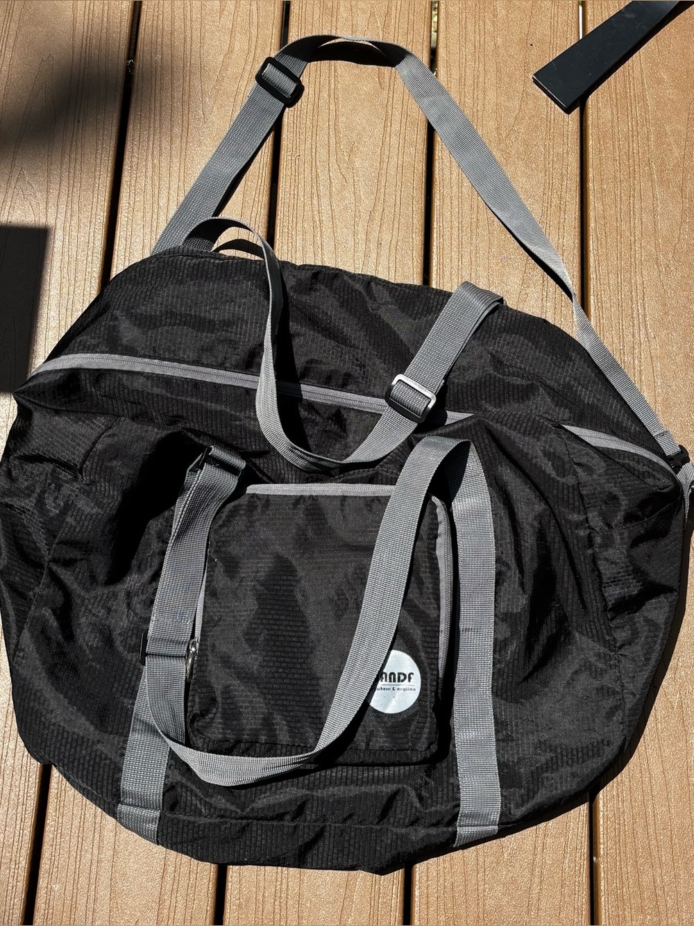 Black Foldable Duffel Bag with Gray Straps and Shoulder Strap